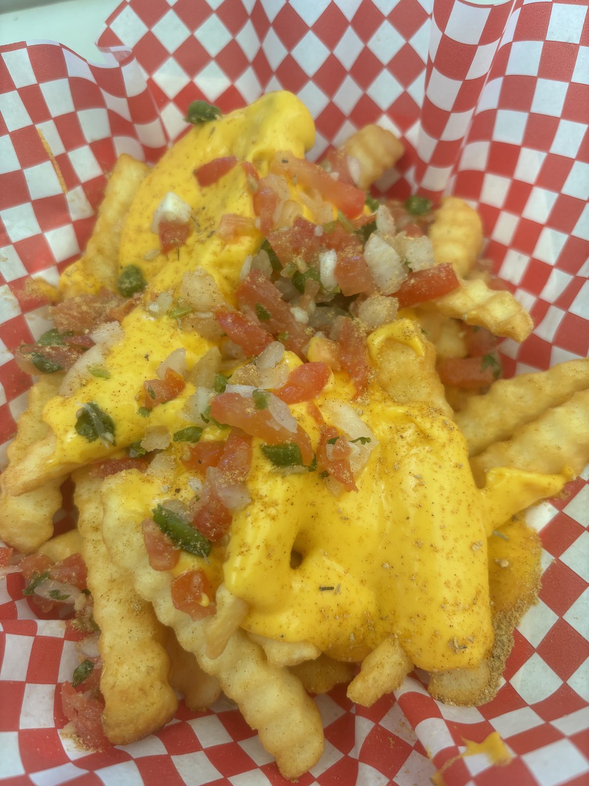 Crinkle cheese fries topped with pico