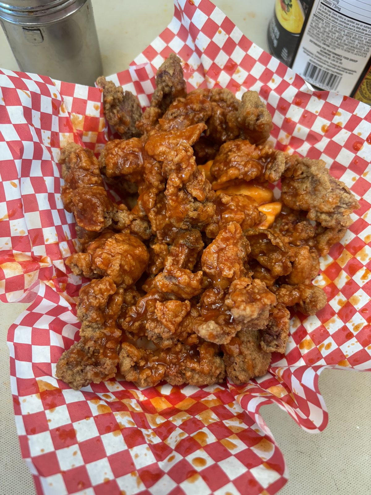 Crispy sauced chicken bites in a checkered basket