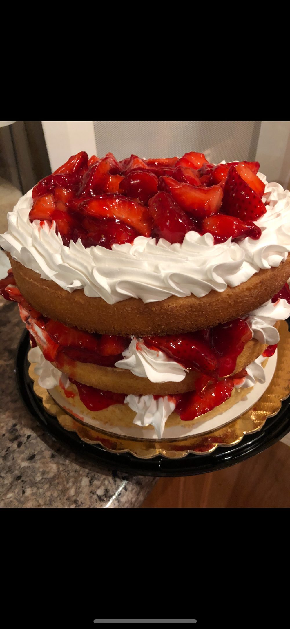 Homemade strawberry shortcake stacked three layers high