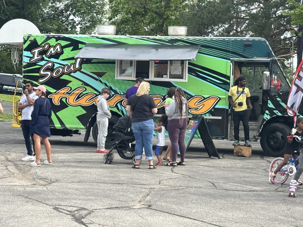 Customers lined up at the I'm Soul Hungry truck window in summer
